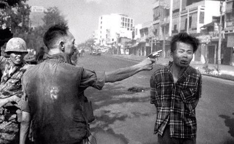 A member of the US puppet government in Vietnam executes a suspect Viet Cong fighter